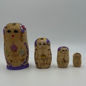 Set of Wooden Nesting Dolls with Purple Accents